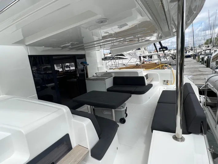 Buena Vida Yacht Photos Pics 2023 Lagoon 50 yacht with spacious outdoor seating and sleek design at marina.