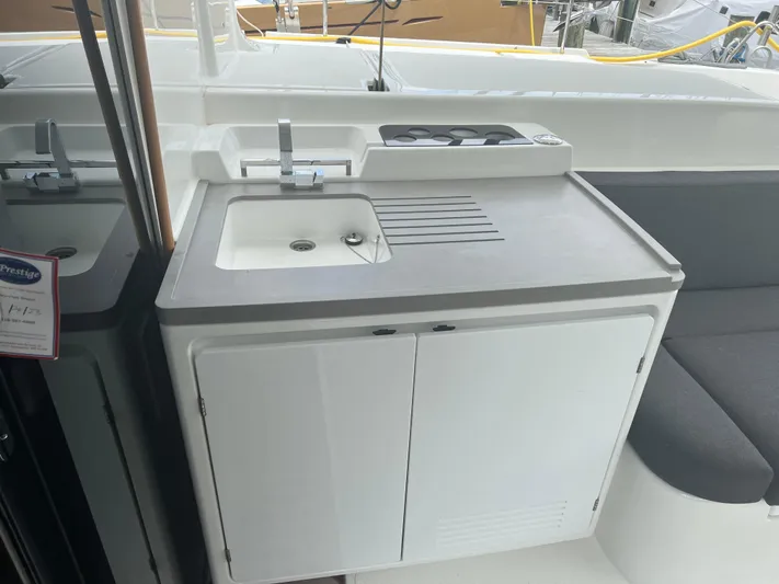 Buena Vida Yacht Photos Pics Outdoor kitchenette on 2023 Lagoon 50 yacht with sink and stove.