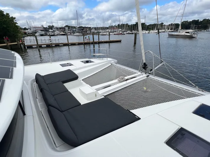 Buena Vida Yacht Photos Pics 2023 Lagoon 50 catamaran with black seating, docked in a marina with sailboats.