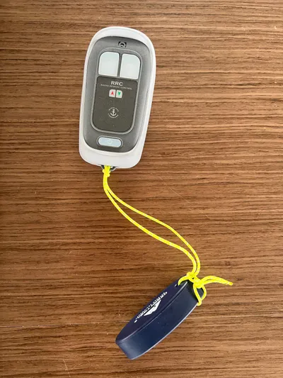 Buena Vida Yacht Photos Pics Remote control for Lagoon 50 yacht, 2023 model, on wooden surface.