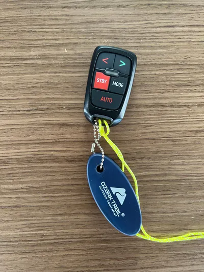 Buena Vida Yacht Photos Pics Remote control with keychain for 2023 Lagoon 50 on wooden surface.