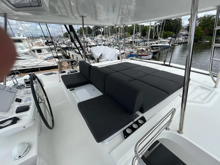 Buena Vida Yacht Photos Pics Luxurious Lagoon 50 catamaran deck with plush seating, 2023 model, docked at marina.