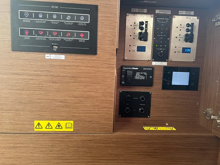 Buena Vida Yacht Photos Pics Control panel of 2023 Lagoon 50 yacht with various switches and indicators.