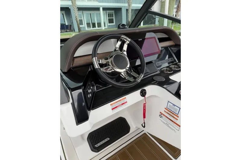  Yacht Photos Pics 2025 Monterey Elite 27 OB boat dashboard with steering wheel and modern controls.