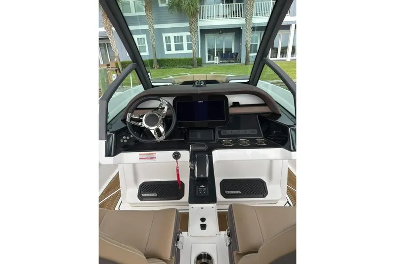  Yacht Photos Pics 2025 Monterey Elite 27 OB boat dashboard with modern controls and steering wheel.