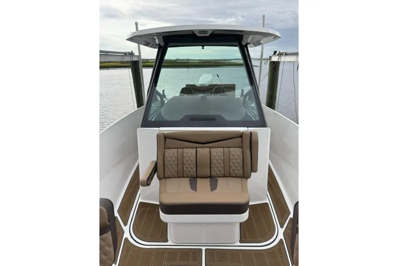  Yacht Photos Pics 2025 Monterey Elite 27 OB boat interior with tan seating and sleek design.