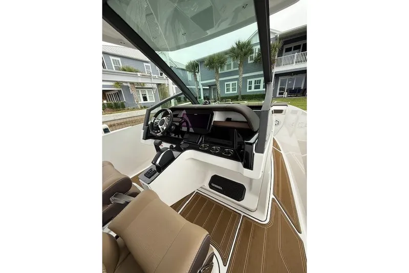  Yacht Photos Pics 2025 Monterey Elite 27 OB boat interior with modern dashboard and seating.