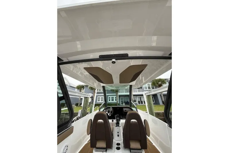  Yacht Photos Pics Interior view of 2025 Monterey Elite 27 OB boat, featuring modern seating and dashboard.