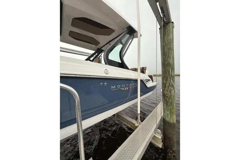  Yacht Photos Pics 2025 Monterey Elite 27 OB boat docked, showcasing sleek design and modern features.