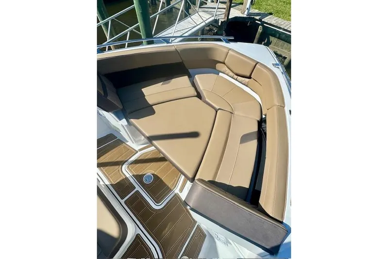  Yacht Photos Pics 2025 Monterey Elite 27 OB boat with tan seating and wood-patterned flooring.
