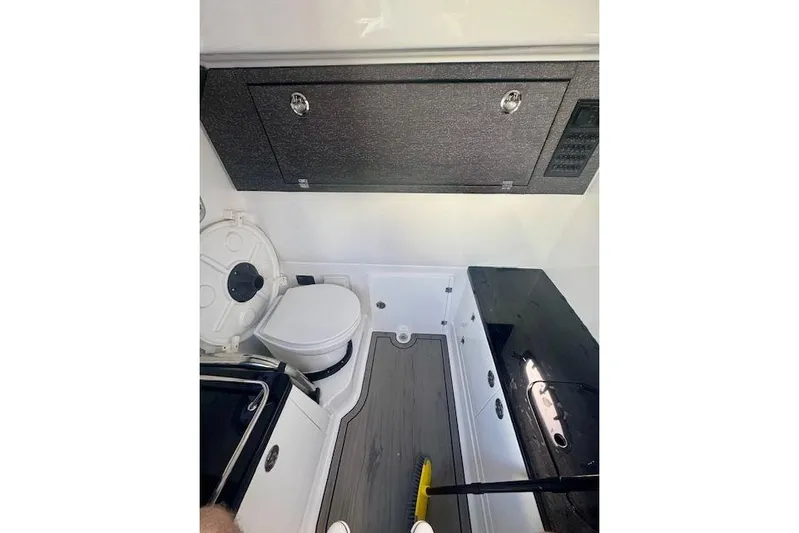  Yacht Photos Pics Interior of 2025 Monterey Elite 27 OB boat, featuring a compact bathroom setup.