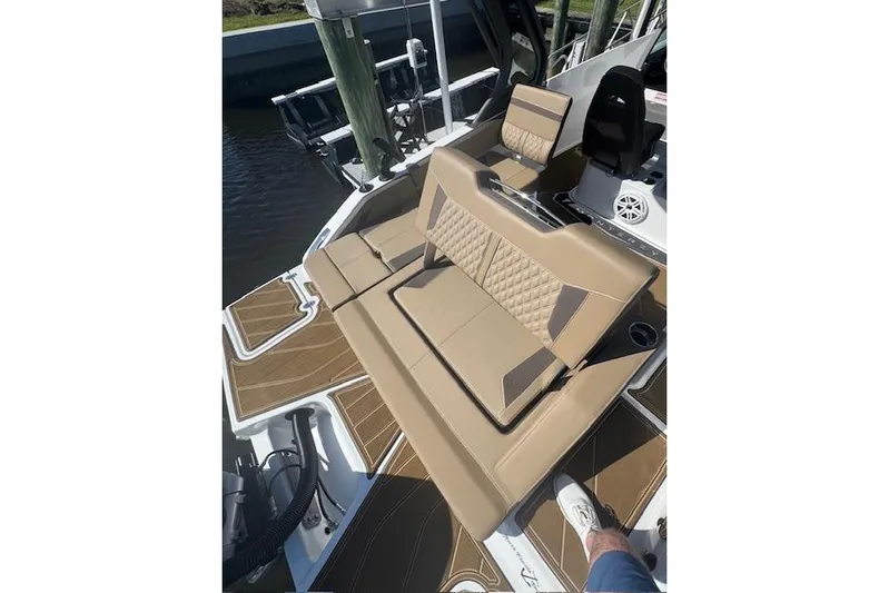  Yacht Photos Pics Luxurious seating on 2025 Monterey Elite 27 OB boat, featuring tan upholstery and stylish design.