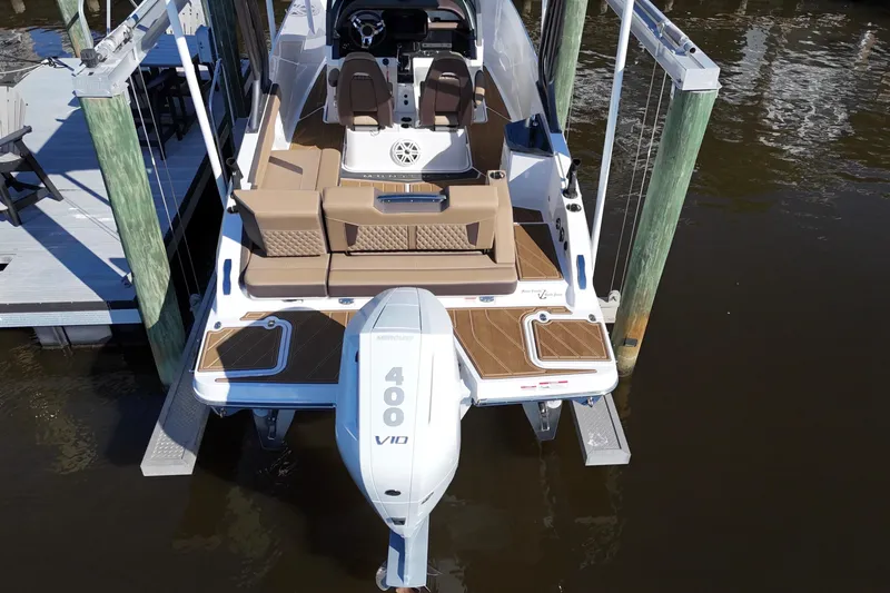  Yacht Photos Pics 2025 Monterey Elite 27 OB boat with Mercury 400 V10 engine, docked on calm water.