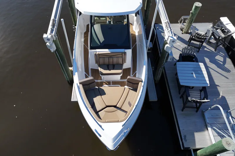  Yacht Photos Pics 2025 Monterey Elite 27 OB boat docked, featuring spacious seating and sleek design.