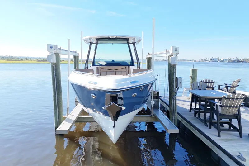  Yacht Photos Pics 2025 Monterey Elite 27 OB boat docked on a sunny day, with waterfront view.