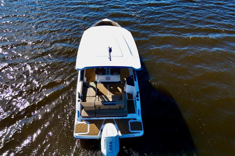  Yacht Photos Pics 2025 Monterey Elite 27 OB boat cruising on open water, aerial view.