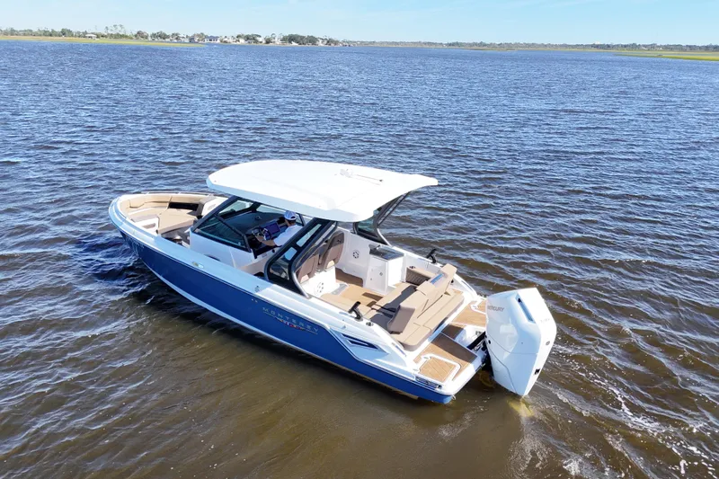  Yacht Photos Pics 2025 Monterey Elite 27 OB boat cruising on open water, showcasing sleek design and luxury features.
