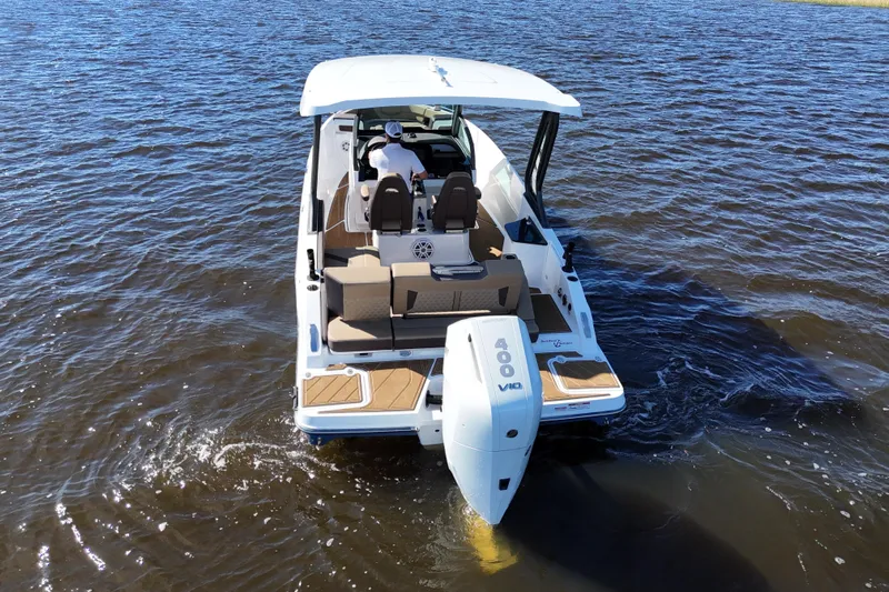  Yacht Photos Pics 2025 Monterey Elite 27 OB boat on water, rear view with outboard motor.