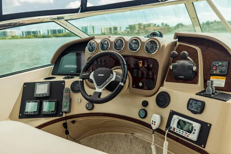 Sonshine Yacht Photos Pics Helm of 2004 Carver 56 Voyager yacht with gauges and navigation controls.