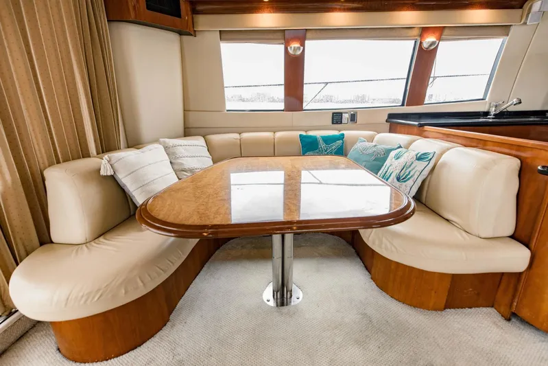 Sonshine Yacht Photos Pics Luxurious interior of a 2004 Carver 56 Voyager yacht with elegant seating and table.