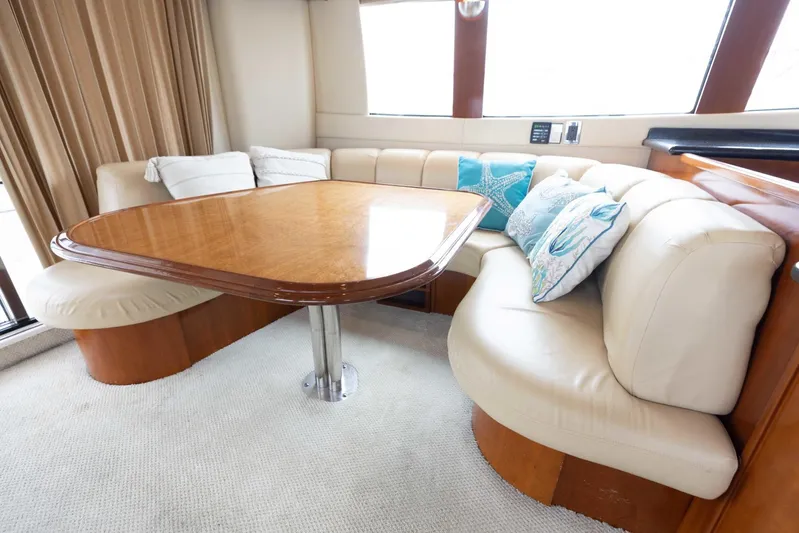 Sonshine Yacht Photos Pics Luxurious interior of 2004 Carver 56 Voyager yacht with plush seating and elegant wooden table.