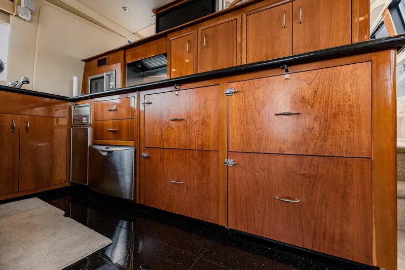 Sonshine Yacht Photos Pics 2004 Carver 56 Voyager kitchen with wooden cabinets and stainless steel appliances.