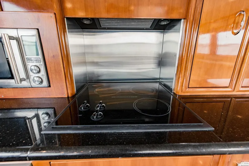 Sonshine Yacht Photos Pics Modern kitchen in 2004 Carver 56 Voyager yacht with stovetop and microwave.