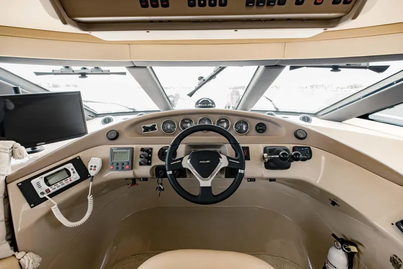 Sonshine Yacht Photos Pics 2004 Carver 56 Voyager helm with steering wheel, gauges, and navigation equipment.