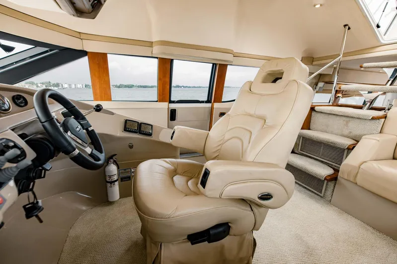 Sonshine Yacht Photos Pics Luxurious interior of 2004 Carver 56 Voyager yacht with captain's chair and helm.