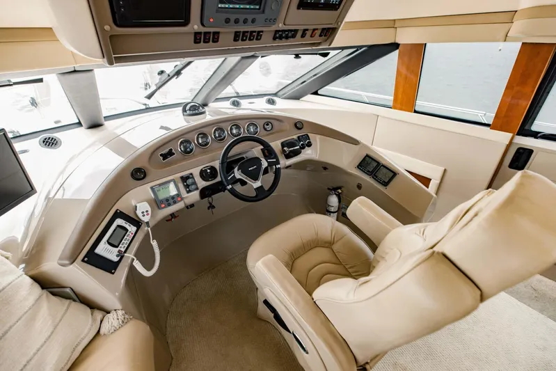 Sonshine Yacht Photos Pics Luxurious helm of 2004 Carver 56 Voyager yacht with plush seating and advanced controls.