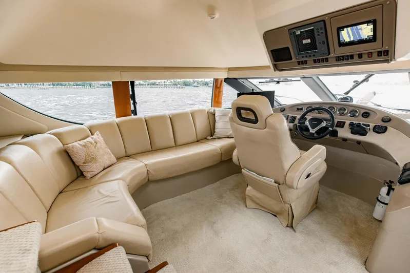 Sonshine Yacht Photos Pics Luxurious interior of 2004 Carver 56 Voyager yacht with plush seating and modern helm.