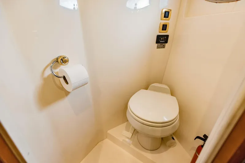 Sonshine Yacht Photos Pics 2004 Carver 56 Voyager yacht bathroom with toilet and wall-mounted controls.