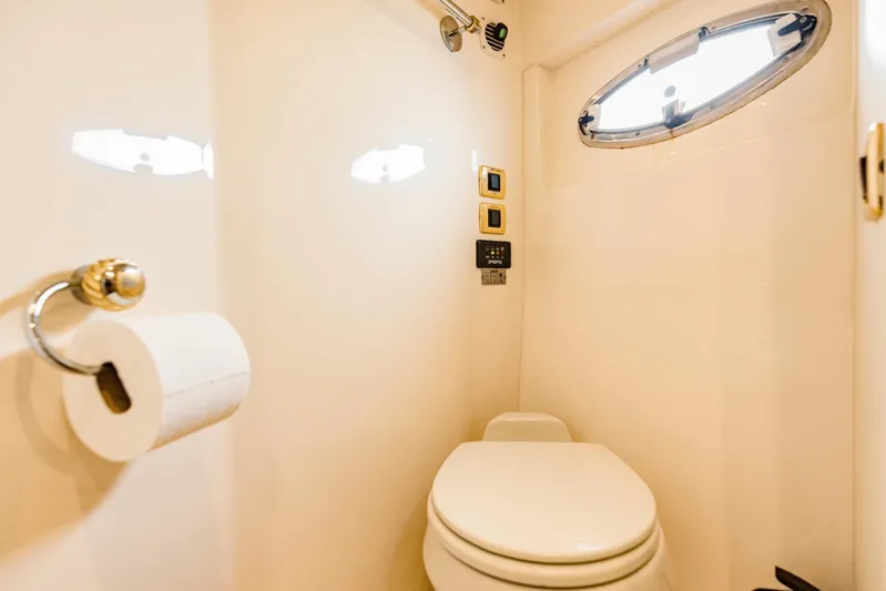 Sonshine Yacht Photos Pics 2004 Carver 56 Voyager yacht bathroom with toilet, porthole, and toilet paper holder.