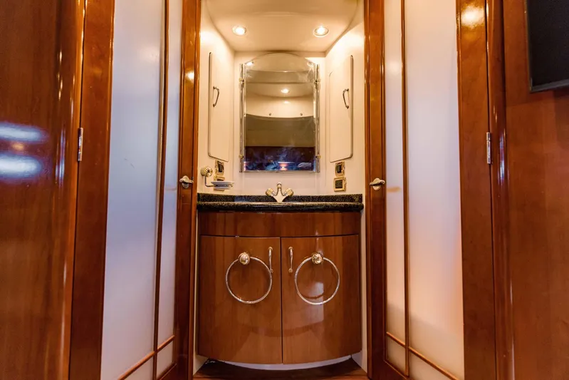 Sonshine Yacht Photos Pics Luxurious bathroom vanity in 2004 Carver 56 Voyager yacht, featuring elegant wood cabinetry.