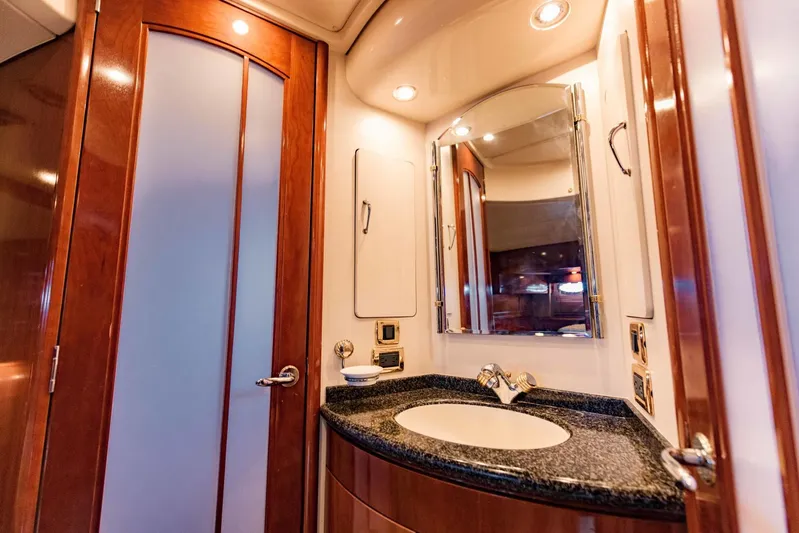 Sonshine Yacht Photos Pics Luxurious bathroom in 2004 Carver 56 Voyager yacht with elegant wood finishes and modern fixtures.