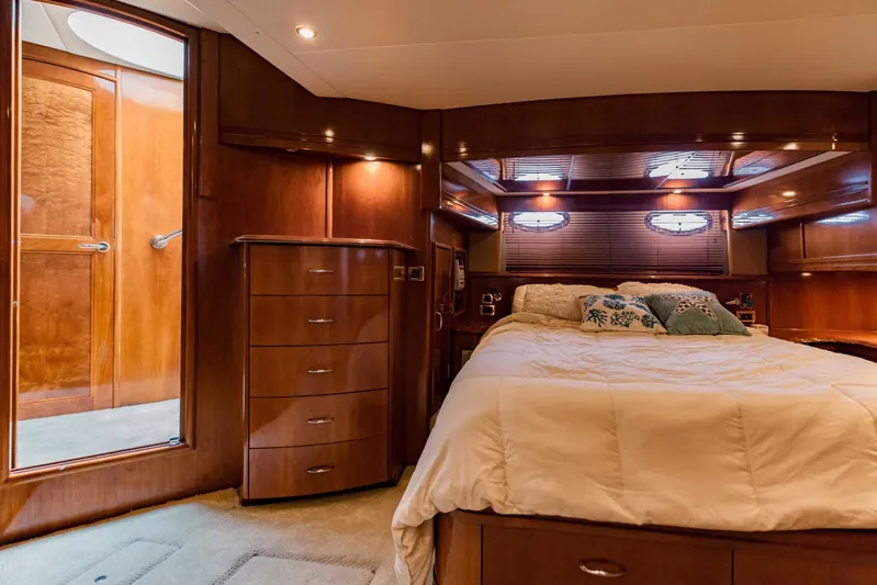 Sonshine Yacht Photos Pics Luxurious bedroom interior of 2004 Carver 56 Voyager yacht with elegant wood finishes.