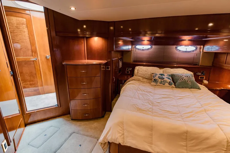 Sonshine Yacht Photos Pics Luxurious bedroom in 2004 Carver 56 Voyager yacht with wood paneling and cozy bedding.