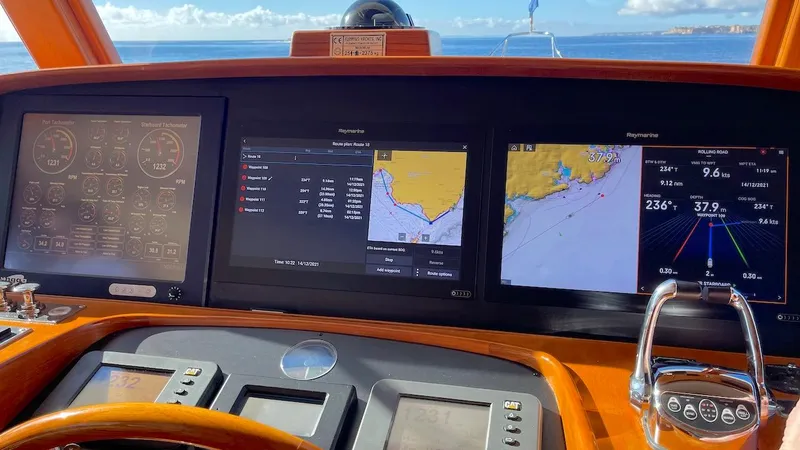 Perseus Yacht Photos Pics Dashboard of a 2004 Fleming 75 yacht with navigation and control screens.