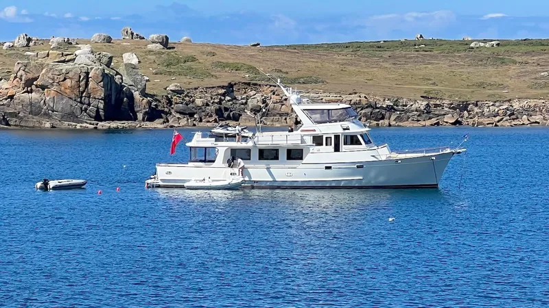 Perseus Yacht Photos Pics Luxury Fleming 75 yacht from 2004 anchored in scenic coastal waters.