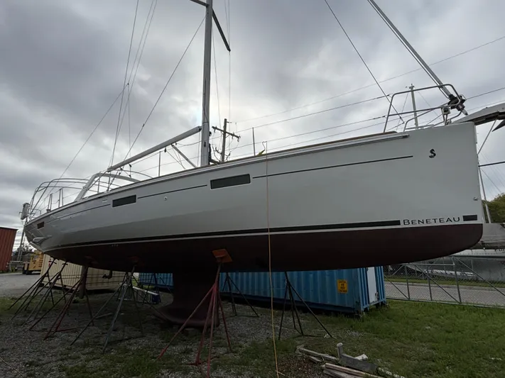 Private Sessions Yacht Photos Pics 2018 Beneteau Oceanis 45 sailboat on stands, overcast sky background.