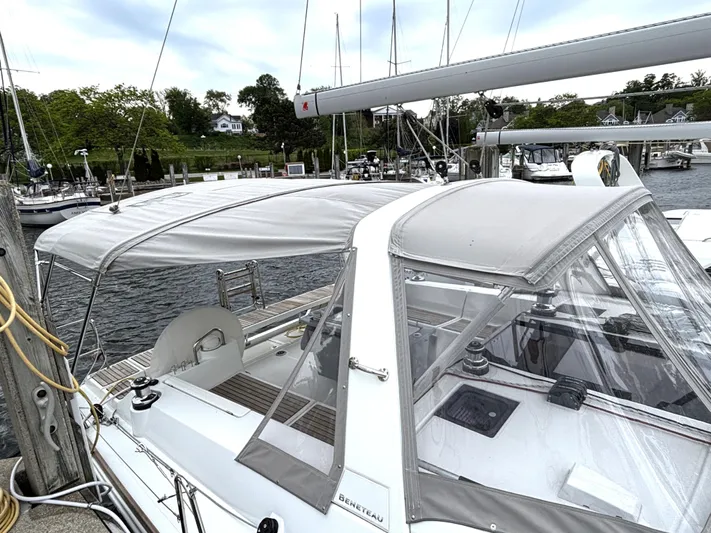 Private Sessions Yacht Photos Pics 2018 Beneteau Oceanis 45 sailboat docked, featuring a covered cockpit and sleek design.