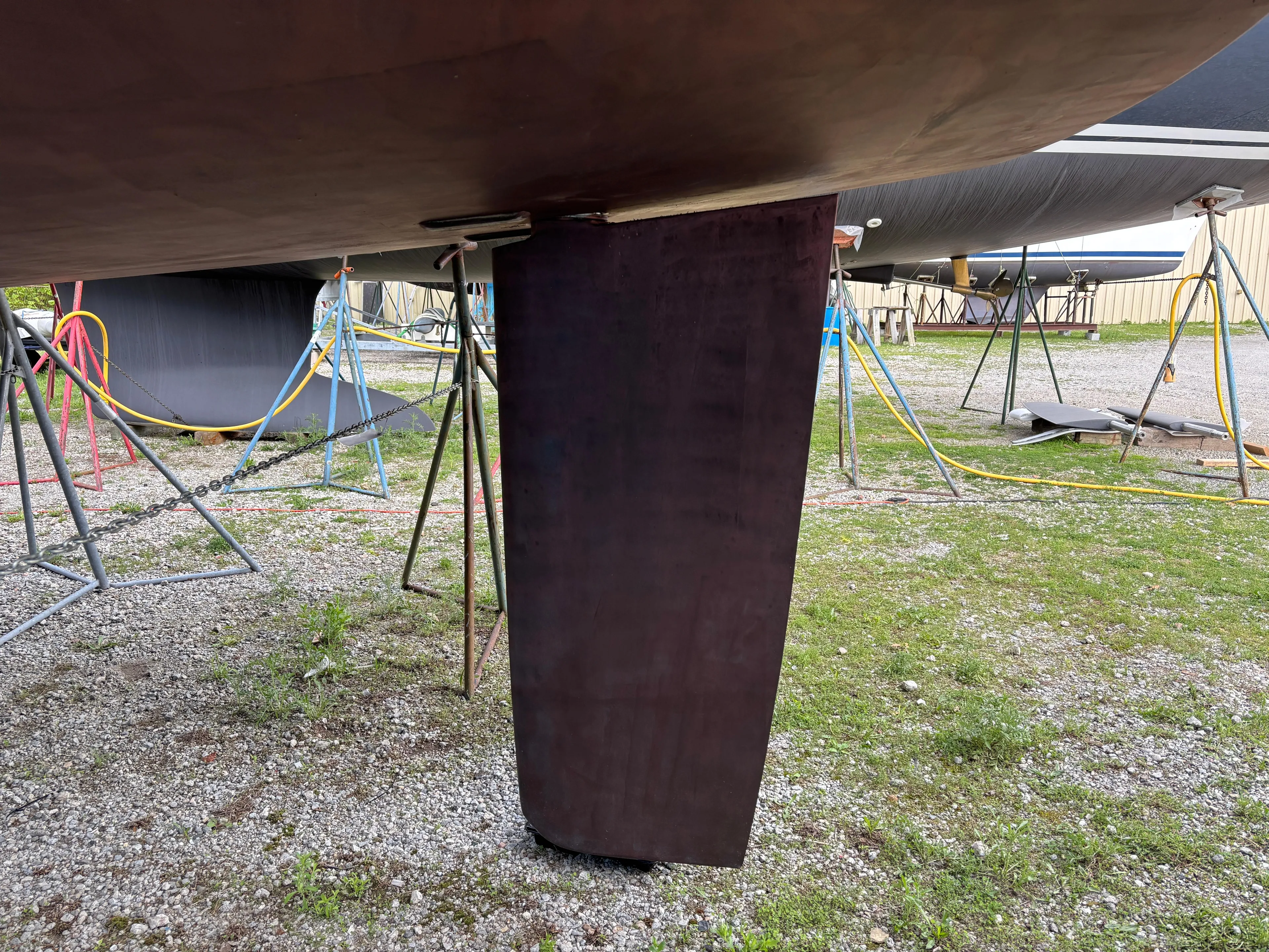 Private Sessions Yacht Photos Pics 2018 Beneteau Oceanis 45 sailboat keel on dry dock, supported by stands.