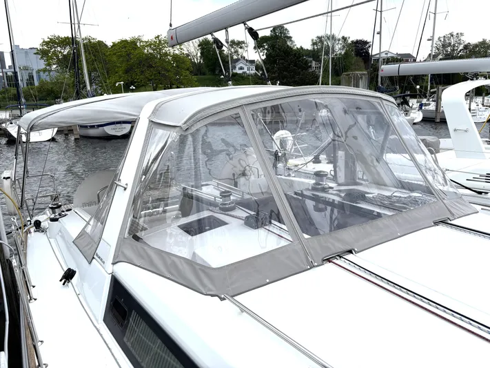 Private Sessions Yacht Photos Pics 2018 Beneteau Oceanis 45 sailboat with cockpit enclosure, docked in a marina.