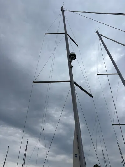 Private Sessions Yacht Photos Pics Tall mast of a 2018 Beneteau Oceanis 45 sailboat against cloudy sky.