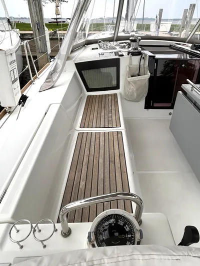 Private Sessions Yacht Photos Pics Cockpit of 2018 Beneteau Oceanis 45 sailboat with wooden flooring and navigation instruments.
