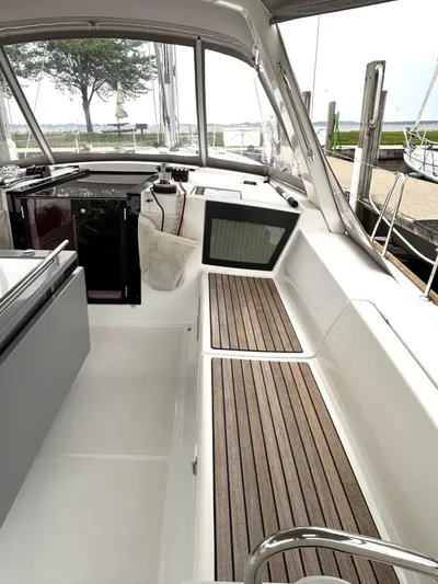 Private Sessions Yacht Photos Pics Interior view of 2018 Beneteau Oceanis 45 sailboat cockpit with wooden seating.