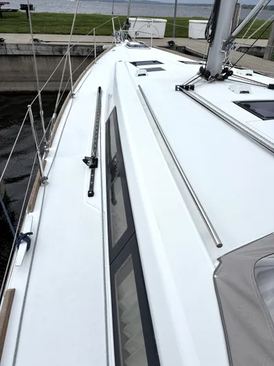 Private Sessions Yacht Photos Pics 2018 Beneteau Oceanis 45 sailboat deck, docked by the water.