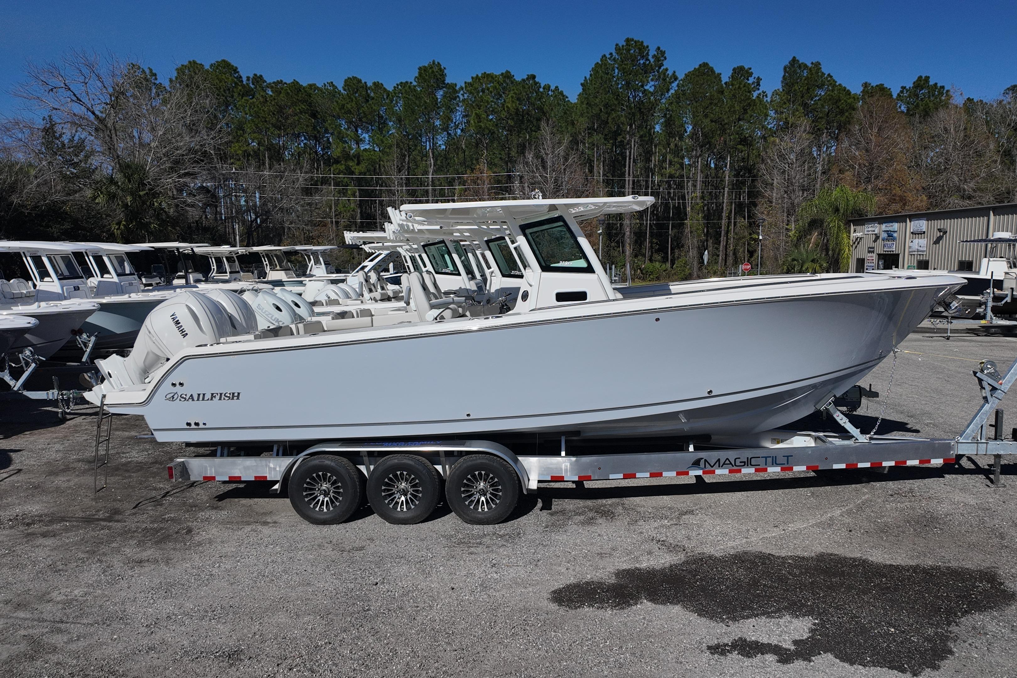 2026 Sailfish 312 CC boat on trailer, parked outdoors, side view.