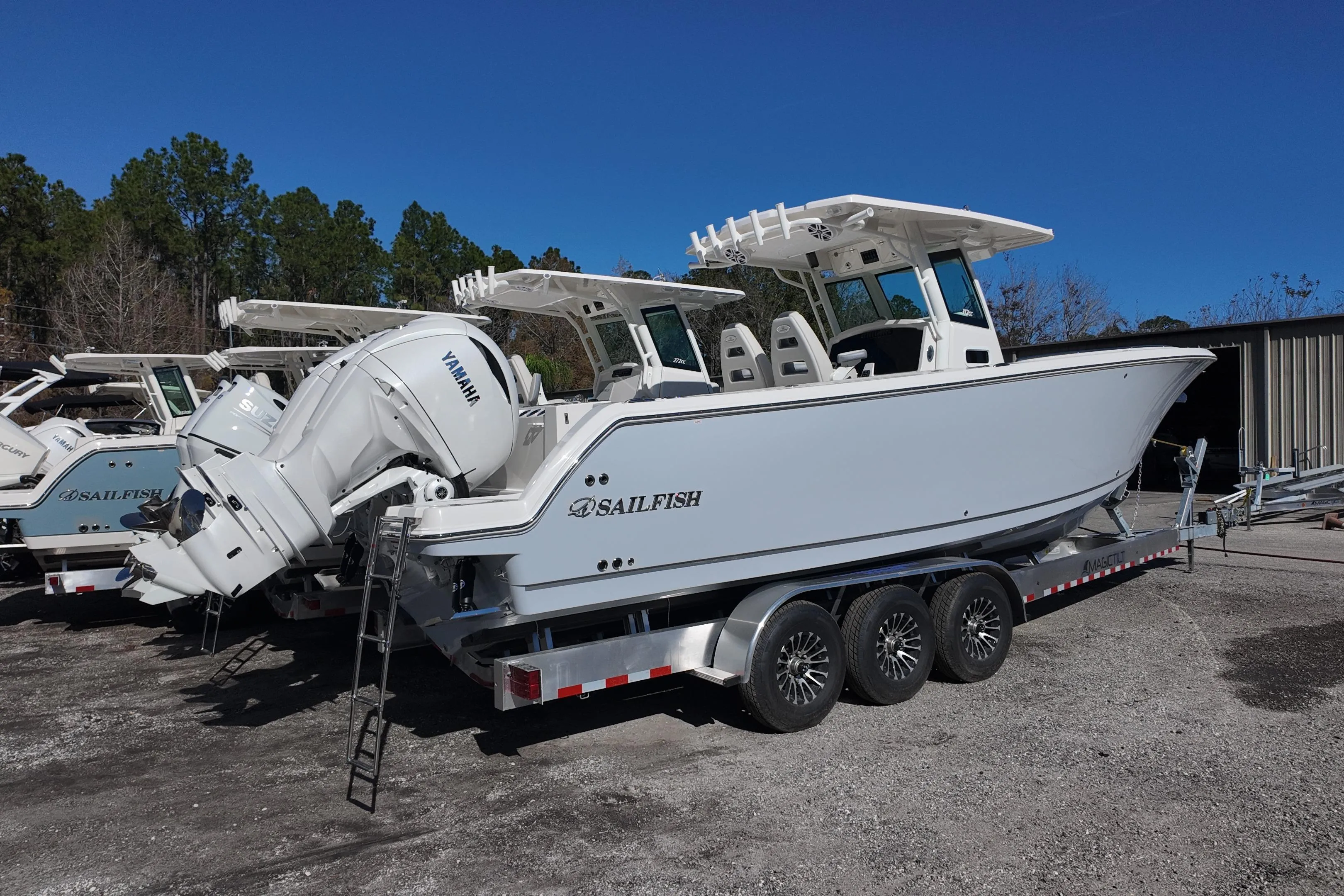 2026 Sailfish 312 CC boat on trailer with Yamaha engines, parked outdoors.