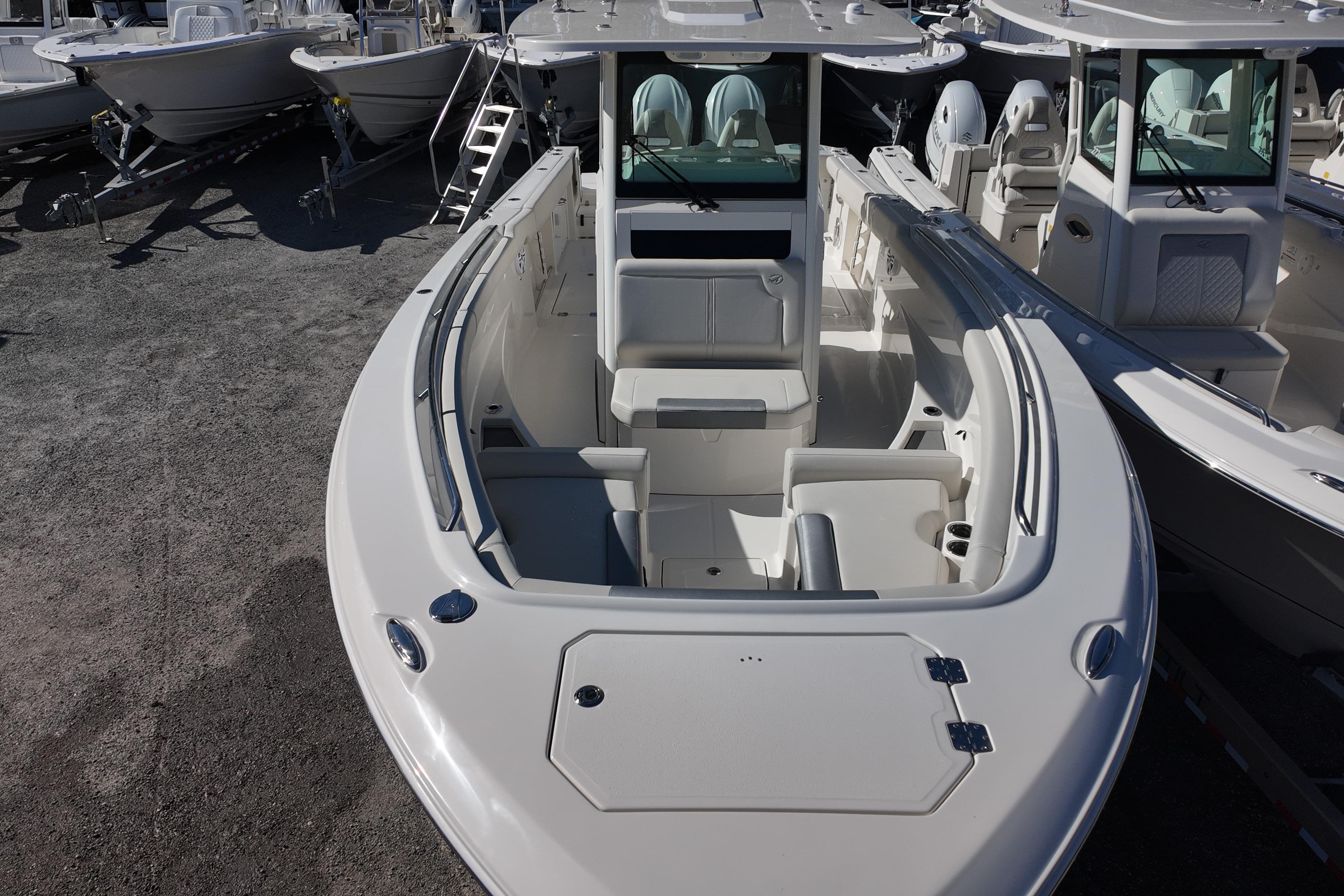 2026 Sailfish 312 CC boat, spacious deck, modern design, parked among other boats.